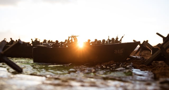 WWII remembrance in Europe World War 2 reenactment (D-day). Creative decoration with toy soldiers, landing crafts and hedgehogs. Battle scene of Normandy landing on June 6, 1944. Selective focus