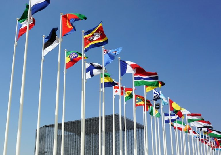 EU NATO partnership 2025 Flags on poles of the world